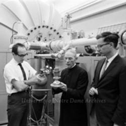 Sperry E. Darden, Brother Cosmas Guttly, and Cornelius P. Browne in front of the new particle accelerator in Nieuwland Science Hall, July 1968