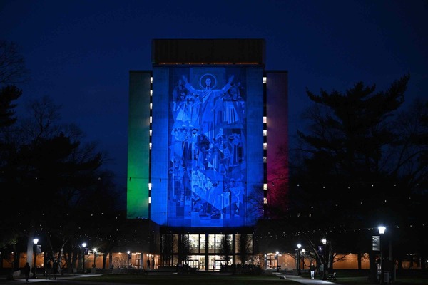 The Word of Life Mural at the Hesburgh Library lit in Rare Disease Day colors