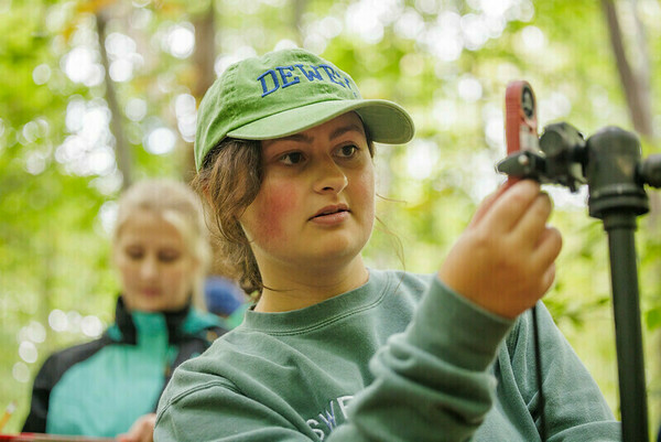 Ecology field trip: close up of student working on tree survey
