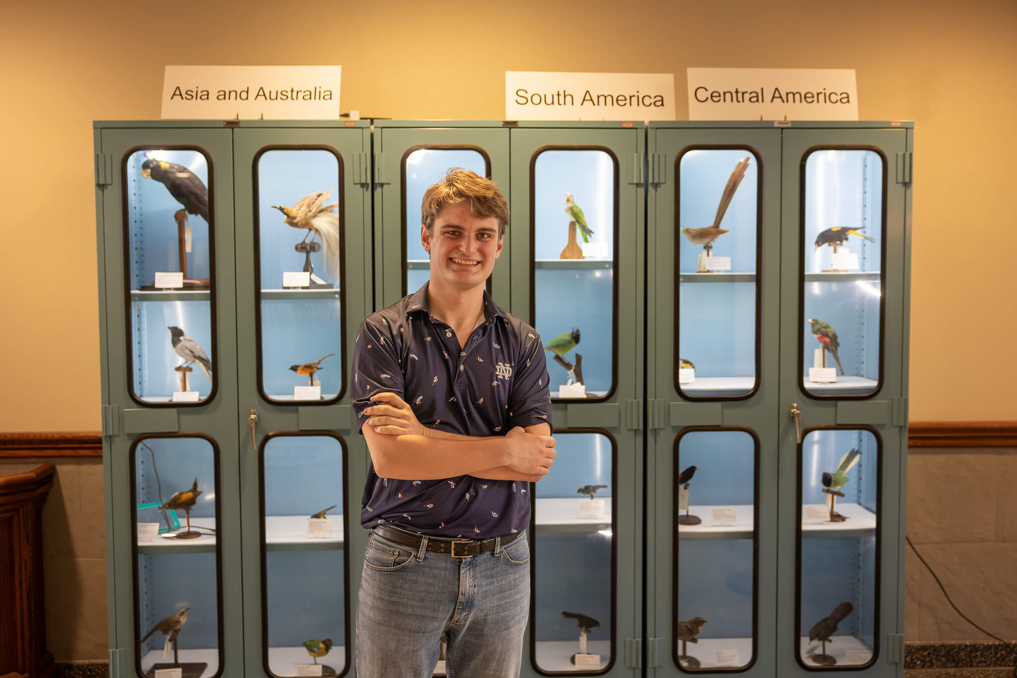 Benedetto stands in front of the Museum of Biodiversity's display of birds in Jordan Hall