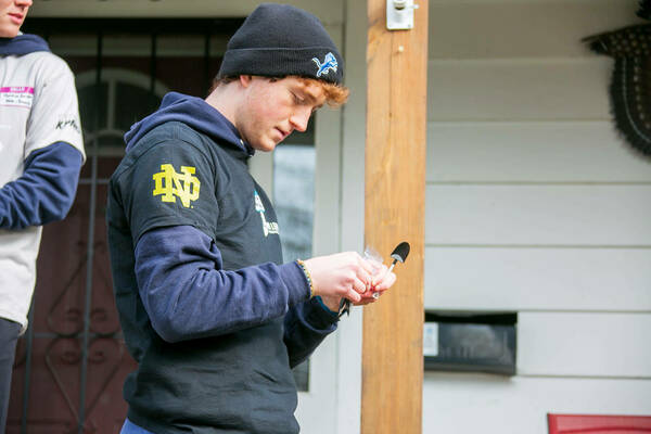 Mason Cohen works at a home during Mulch Madness, an annual lead poisoning prevention project.