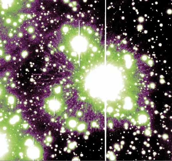 Star J005311: Bright white and green stars and galaxies glow in a purple and black nebula.