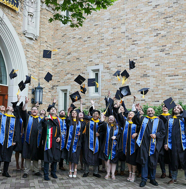The Class of 2024 throwing their graduation caps at commencement.