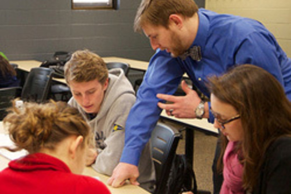 Brian Shourd works with a group in his Calculus III class.